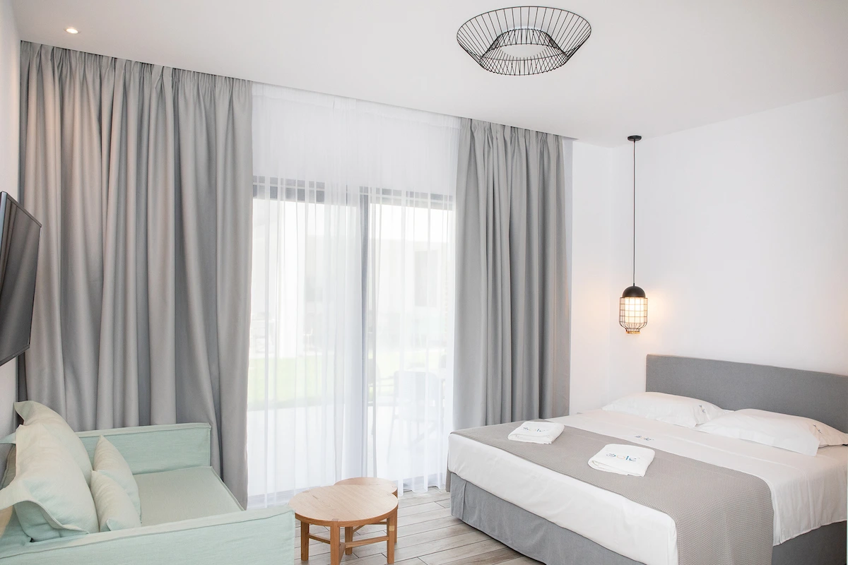 Patio room with large window and garden views at Suites Sole, Keramoti